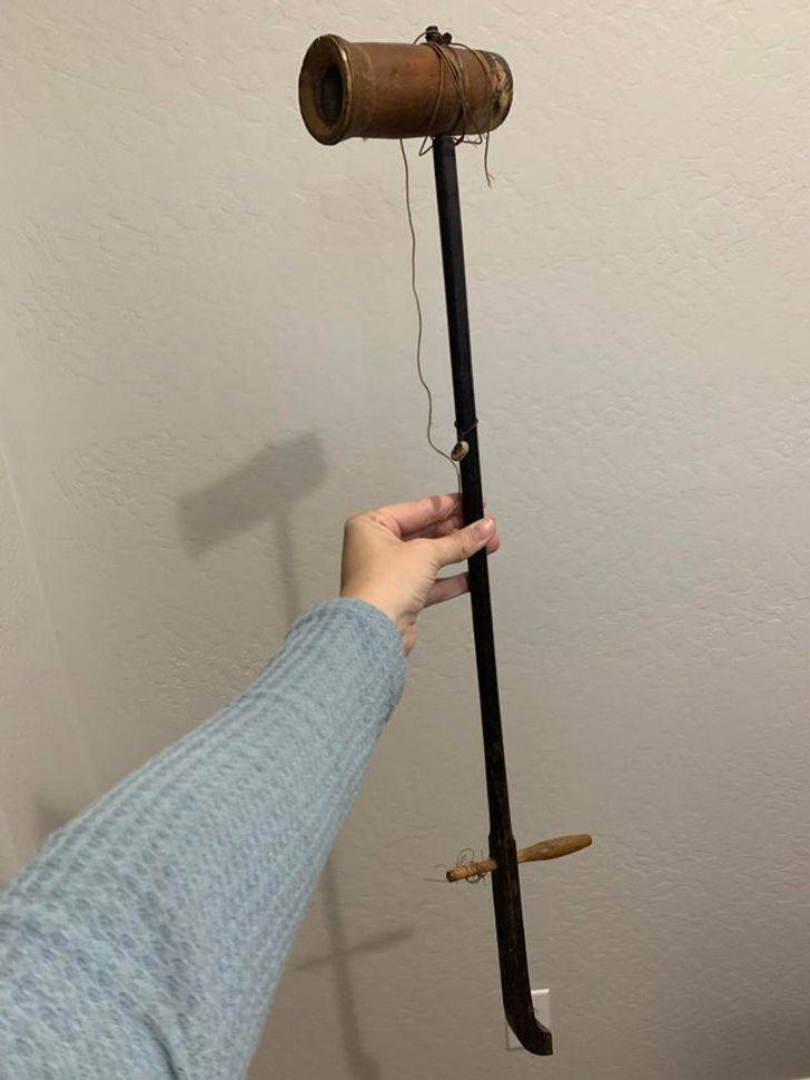 “This was given to us when my father-in-law passed away, and we don’t know what it is!”

A: “Looks like an erhu to me. It’s an old, beat up Chinese fiddle (missing a string, tuning peg, and sound tube cover) for sure. That being said, the button does serve a purpose. It’s supposed to be used as a kind of guide for the string.”