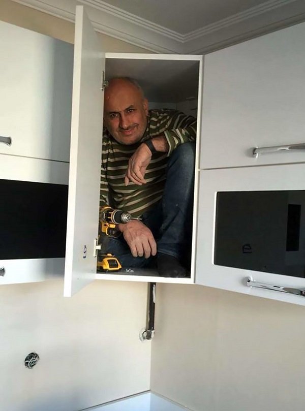 Contractor gets into a cabinet to prove that it is very sturdy.