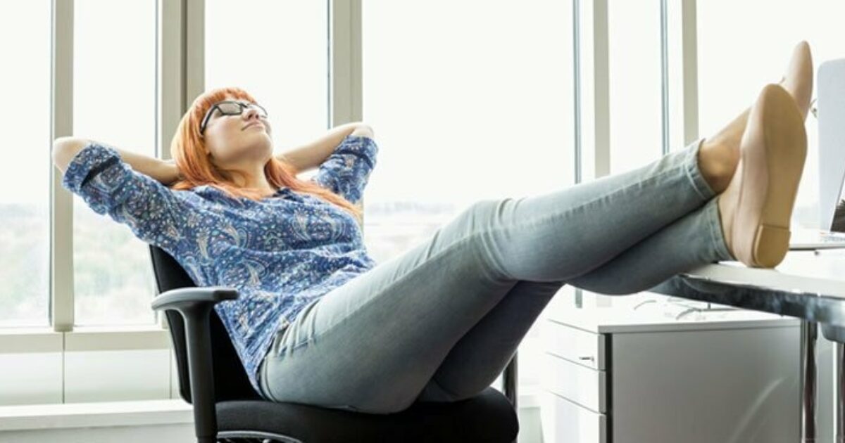 woman sitting with feet up on desk