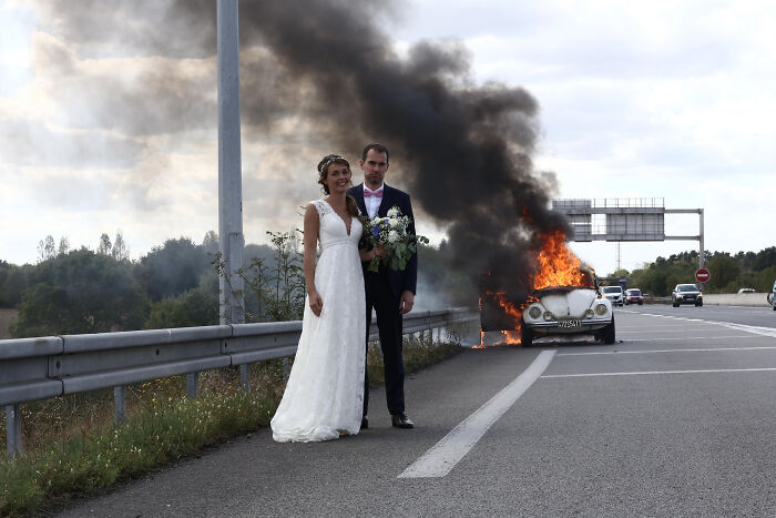 Newly Wedded In Front Of Their Burning Car