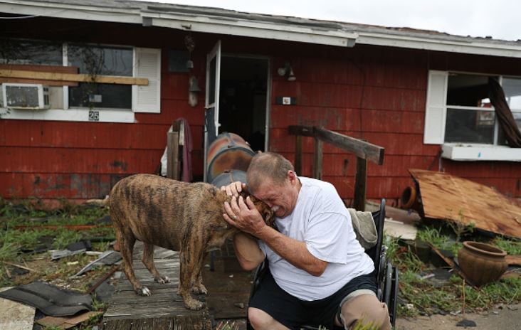 feel good pics - guy crying holding his dog