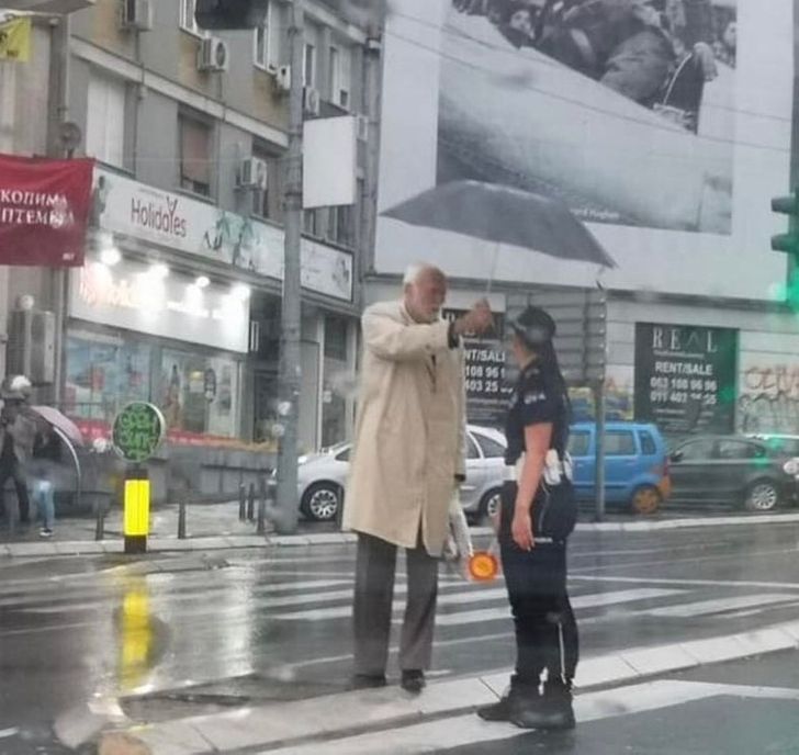 This nice man protecting an officer from the rain in Serbia