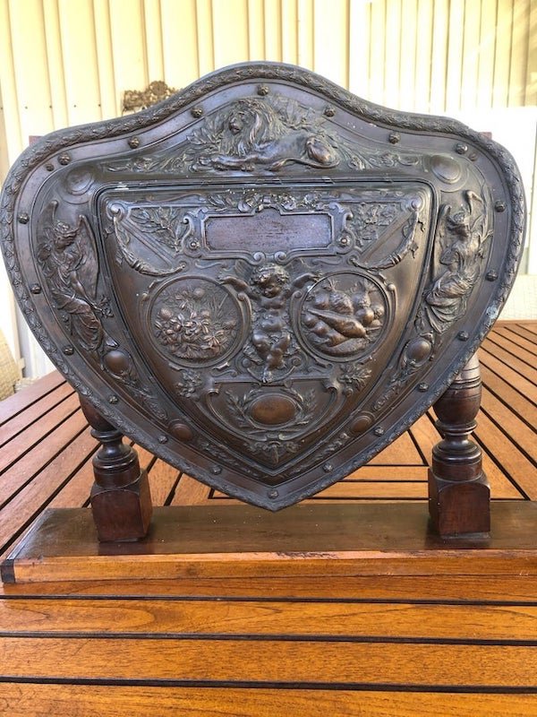 An old shield from my grandparents. About 30cm across. Has “Elkington” inscribed on the back.

A: Looks like Elkington & Co used to be an electroplate manufacturing company that made replica shields, among other things.