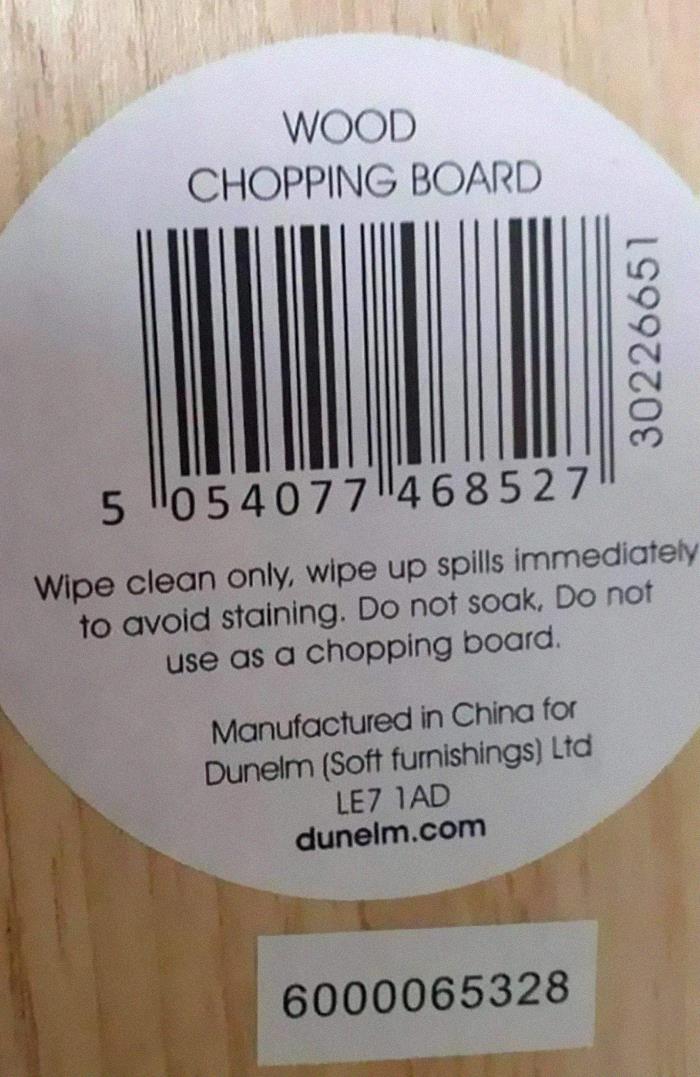 label - Wood Chopping Board 30226651 5 "0540771468527 Wipe clean only, wipe up spills immediately to avoid staining. Do not soak, Do not use as a chopping board. Manufactured in China for Dunelm Soft furnishings Ltd LE7 Iad dunelm.com 6000065328