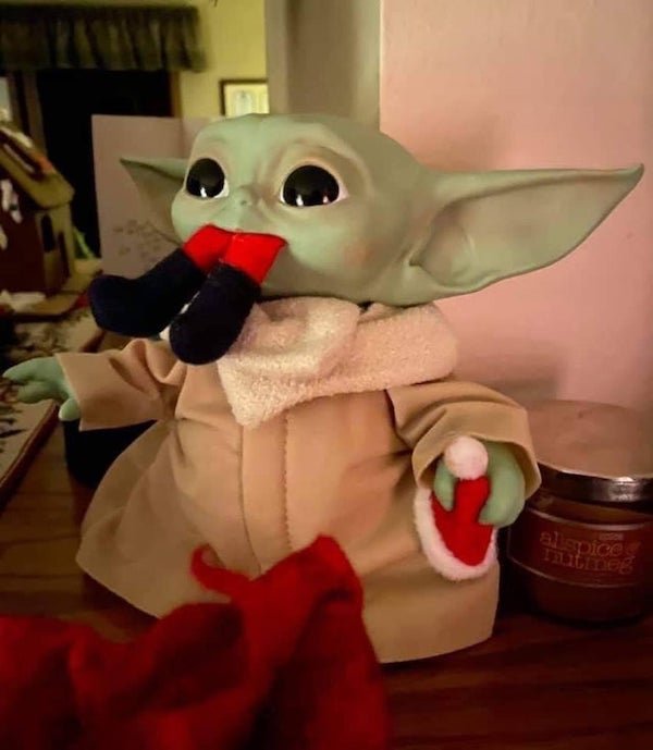 funny pictures - baby yoda doll eating santa