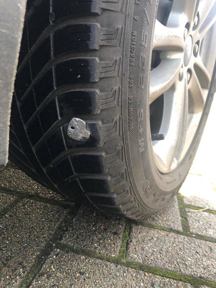 funny fail pics - car tire with a key stuck in it