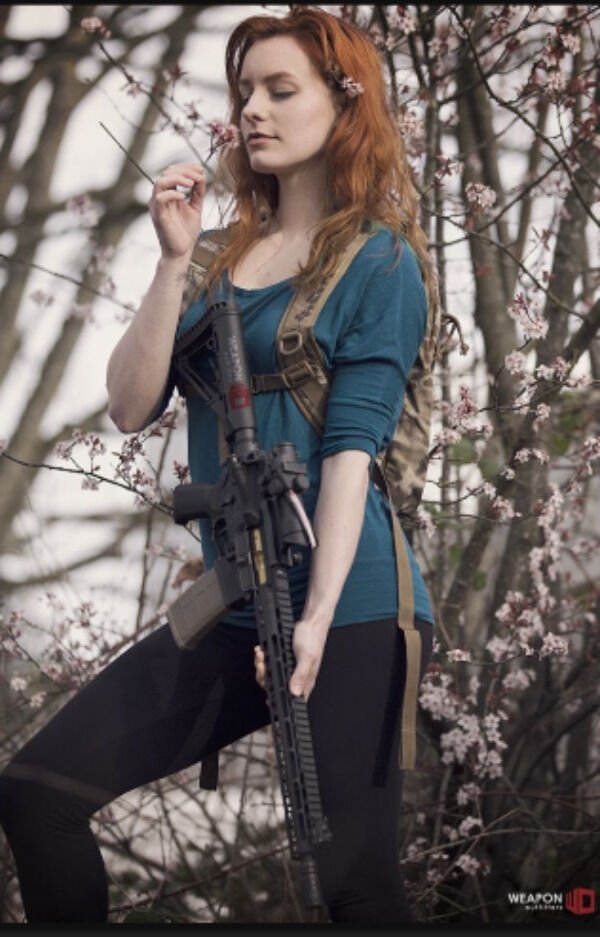 funny memes - sexy woman smelling a flower holding a rifle