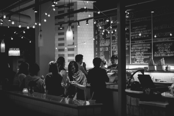 people in cafe black and white