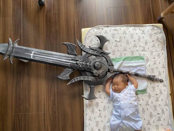 funny pics and memes - baby holding a giant sword