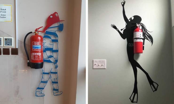 "Fire extinguisher art in the form of a firefighter and a scuba diver"