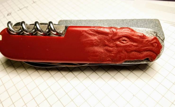 “A piece of my swiss army knife's handle chipped off, so I carved a dragon's head in the plastic to hide it.”