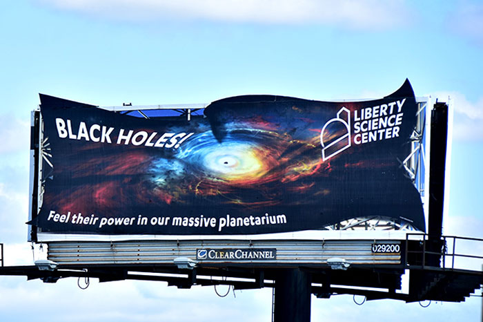 billboard - Feel their power in our massive planetarium Black Holes! Liberty Science Center 029200 Clear Channel