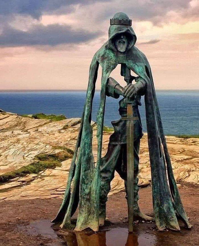 statue of king arthur located in a castle in cornwall