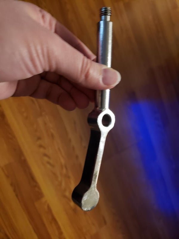 Found this odd steel tool after a break-in

A: It’s pull arm for a soft serve ice cream machine. You pull down on it (the screw part usually has a knob on it).