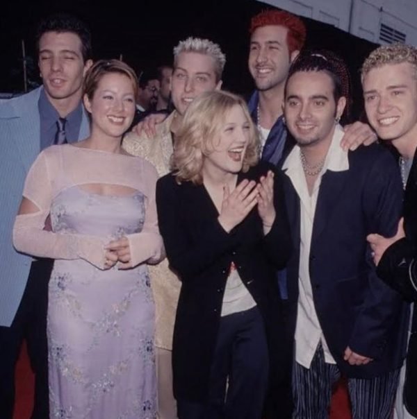 NSYNC posing with Sarah McLachlan and Drew Barrymore at the 1999 Blockbuster Awards.