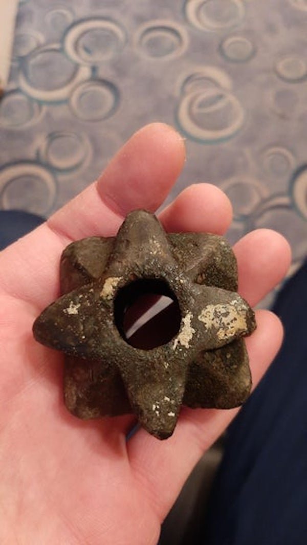 Cast iron object dug out of the ground. The two holes are not the same size. Dimensions: 5x5x3 cm. What is it?

A: You have what looks like a Kirpichnikov Type mace head. Posibbly pre-14th century or a recreation. Excellent find!