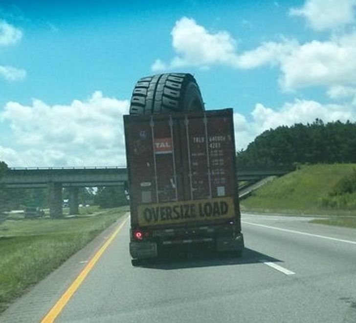 “Huge tire being transported on the highway.”