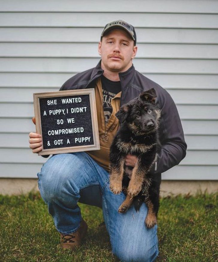 funny relationship pics - sad man holding dog and sign that says: she wanted a puppy, I didn't so we compromised and got a puppy