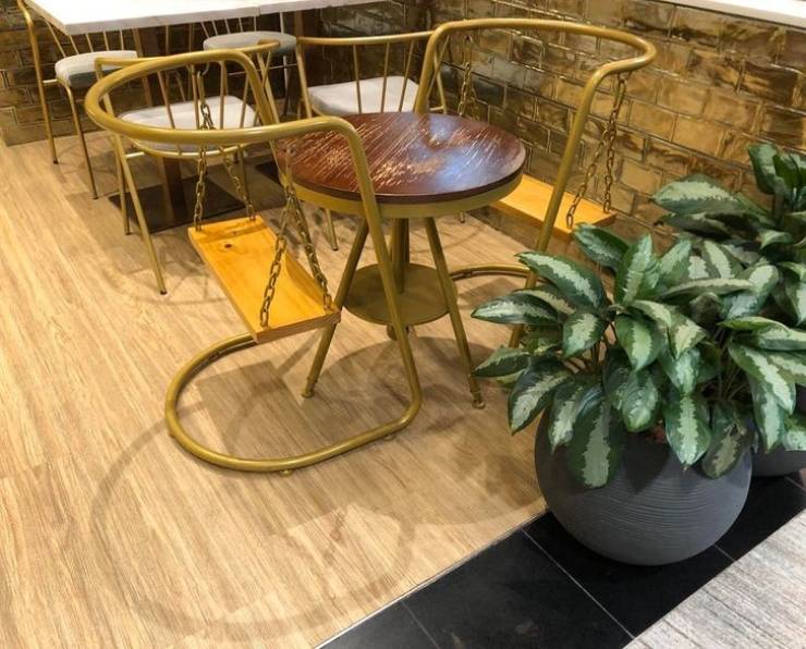 “Swing chairs inside of a cafe at Singapore International Airport”