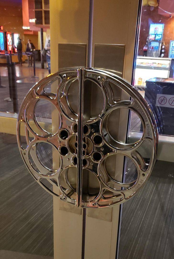 “The door handle at this movie theater is a film reel.”