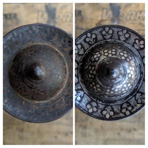 "Before-and-after cleaning of a 300-year-old silver-inlaid sword pommel."