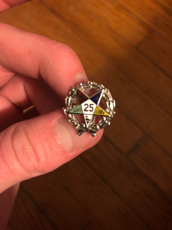 Does anyone know what this is? Is it military or just decorative.

A: 25 year membership pin awarded to a member of the Order of the Eastern Star (OES) a woman’s auxillary group for female relatives of Freemasons.