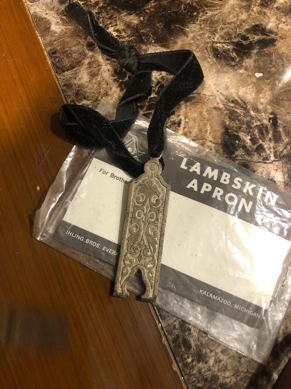 Coworker bought a really old Masonic mansion to convert into a haunted house. They found this in it. Any idea?

A: Jewel for the Jr Warden to wear