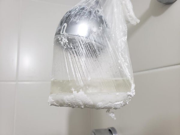 We noticed that the shower was getting white spots where the water comes out. We isolated it with a plastic bag, and after a week this white powder accumulated. Is it something added to treat the water?

A: Probably Limescale. Mineral buildup in hard water. Typically harmless, but that looks like a lot of that’s what it is.