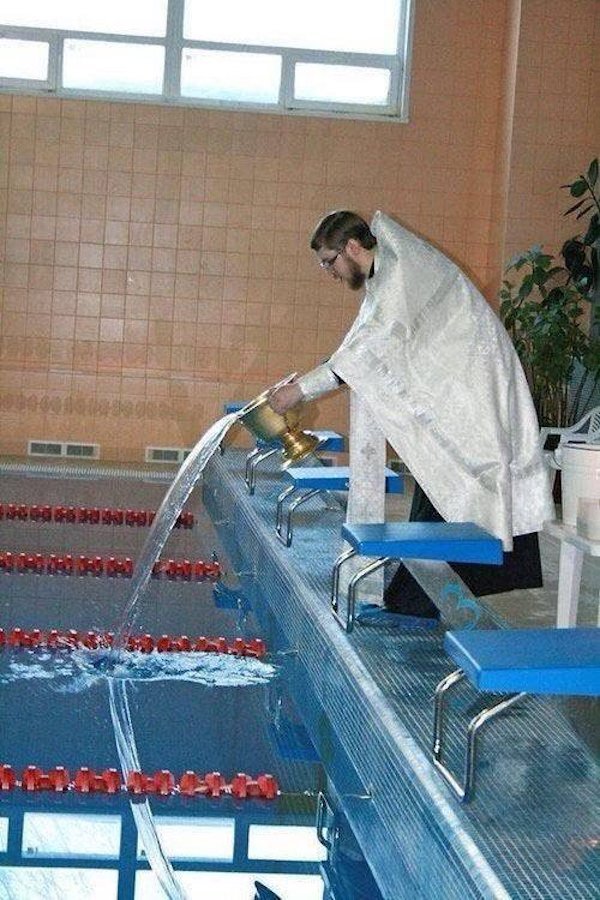funny pics - religious man pouring out holy water into a swimming pool