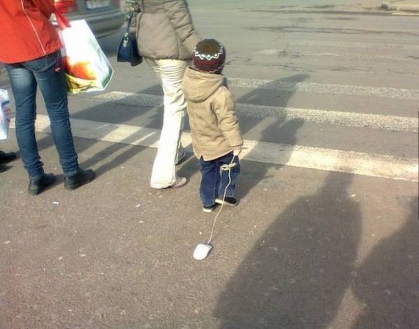funny pics - kid holding a computer mouse crossing the street