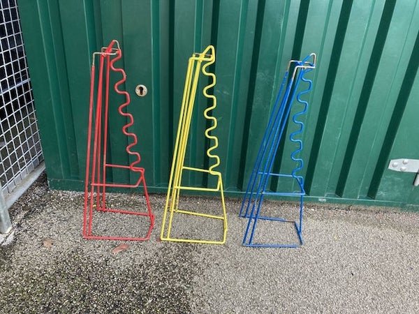 In a UK primary school. I remember seeing these as a kid but can’t remember what they’re for! Holding something? But what?

A: We used in primary school to hold canes to jump over.