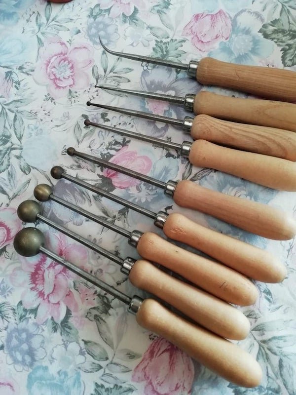 It has a wooden handle and other parts are iron. All of them has balls except the last one is pointy. Think its old bc we found it at my granny’s attic.

A: They are millinery tools — for making fabric flowers.