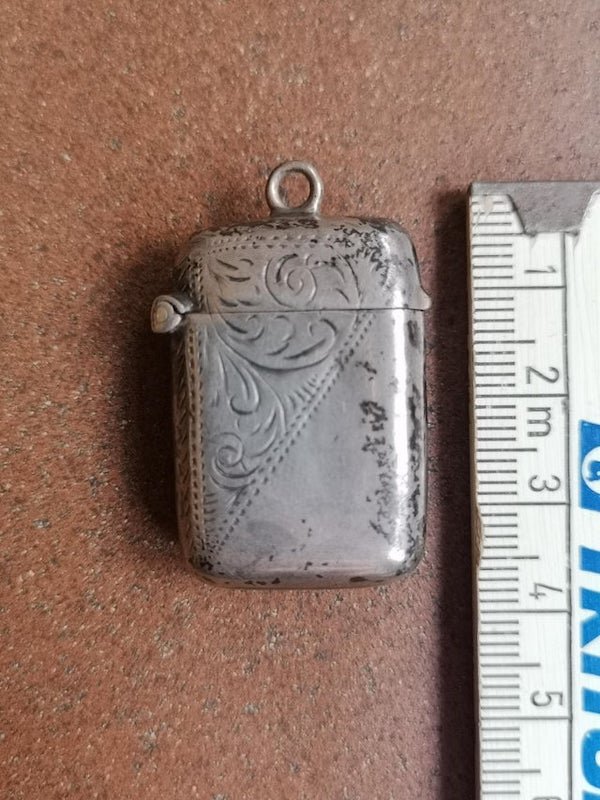 Little silver box. Looks like a pendant for a necklace. 1.2 x 0.8 inches (3 x 2 cm). There is an engraving: B&S, “anchor”, “lion”, b – There was a price tag inside mentioning: $ 80, Vesta Birmingham England 1901

A: It’s a holder for matches and striker.