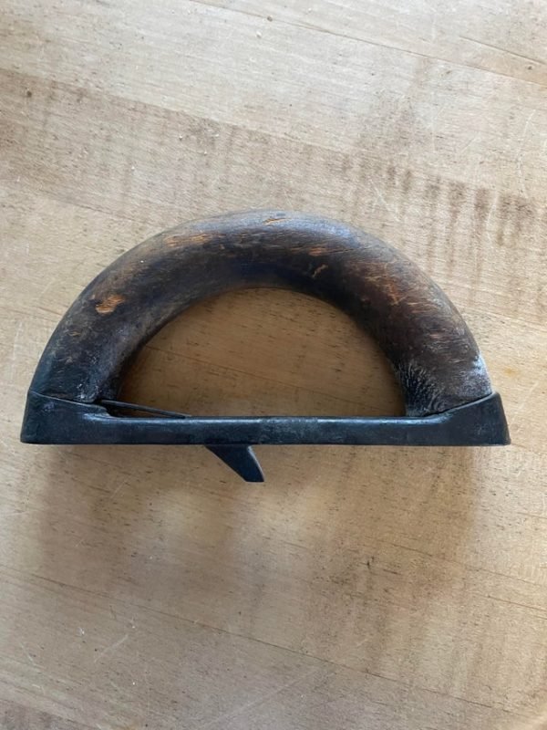 What is this (tool?) used for?

A: It’s the handle to a sad iron. The base is heated on a stove. A removable handle allows one base to heat while another is being used.