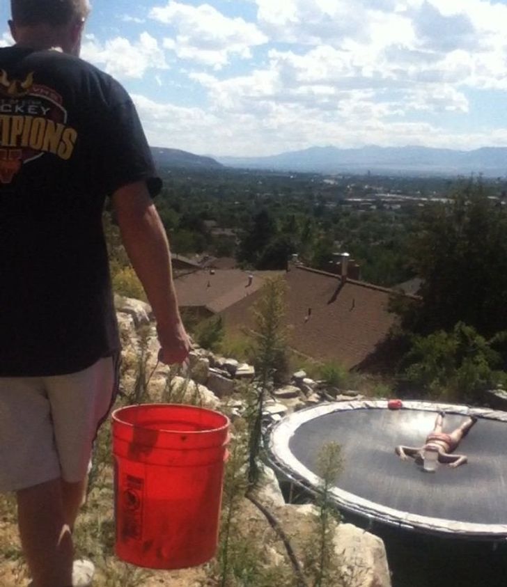 funny sibling pics - guy about to pour bucket of ice water on his sister