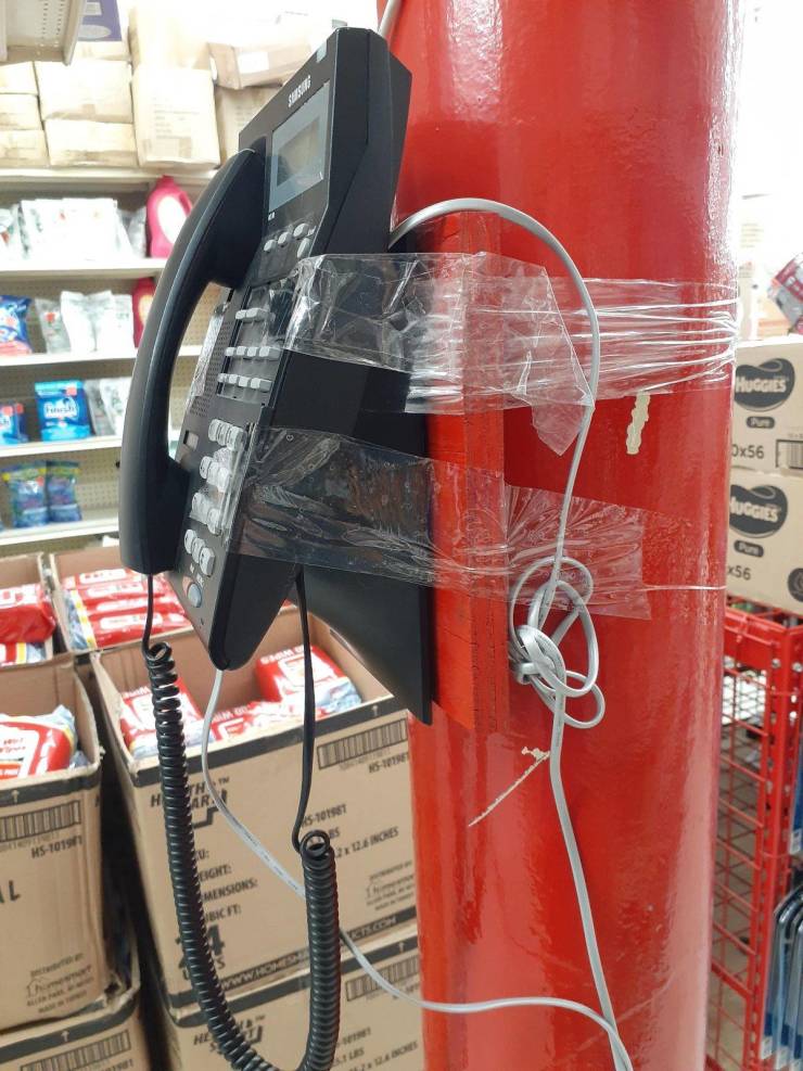 funny pics - telephone taped to a pole in a store
