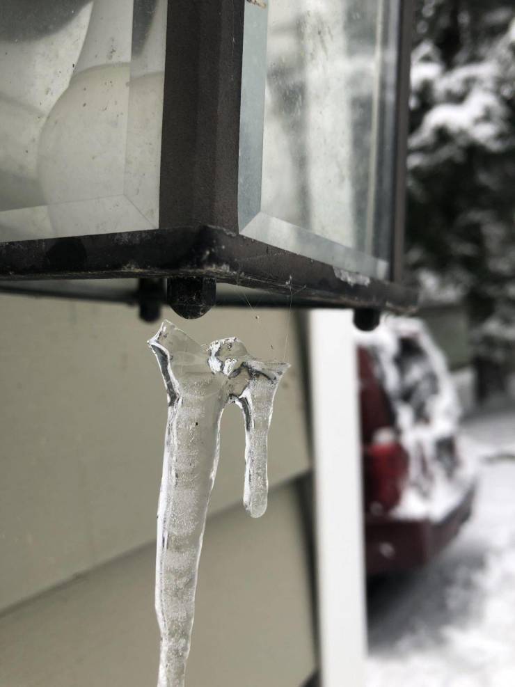 “Icicle being hung by a few strands of spider web.”