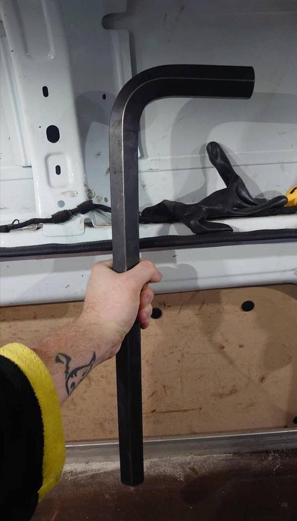 funny pics - man holding huge allen wrench