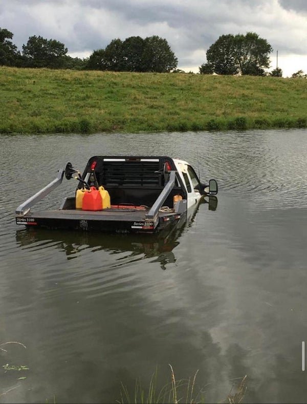 funny fail pics - truck sinking into lake with fuel in the back