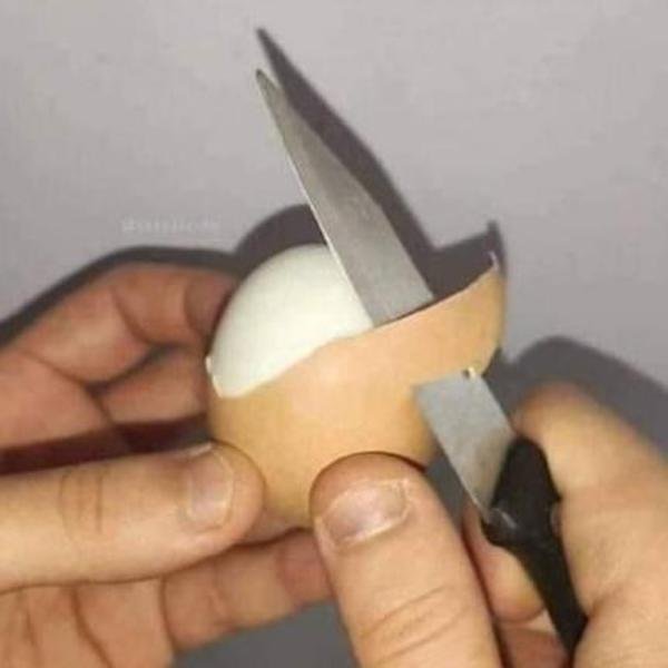 funny pics - guy peeling an egg shell with a knife