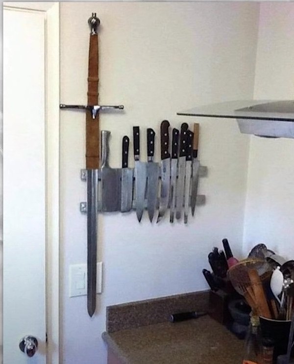 funny pics - giant sword hung up next to kitchen knives