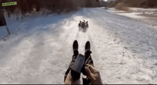 cool stuff - gif guy traveling on snow using RC car to pull him