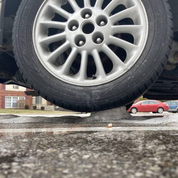 “My car tire balancing on only a tiny patch of snow, somehow not collapsing, after all the snow around it melted.”