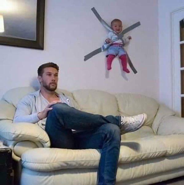 baby duct taped to wall