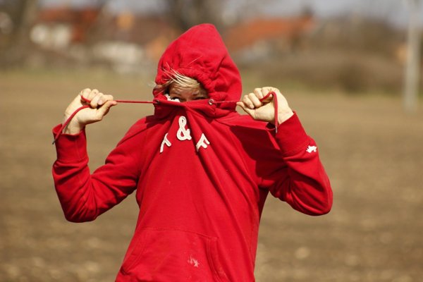 person hiding face with hoodie - ?