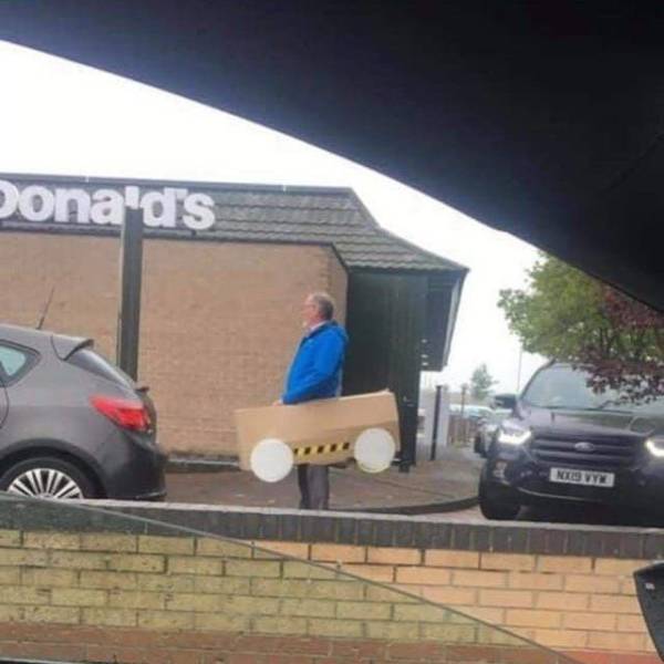 man in cardboard car at mcdonalds