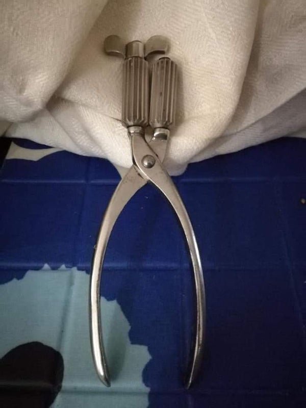 What is this plier-handled tool with gear-toothed rollers turned by a wing crank at the top?

A: It’s for the ribbons on old pillowcases.