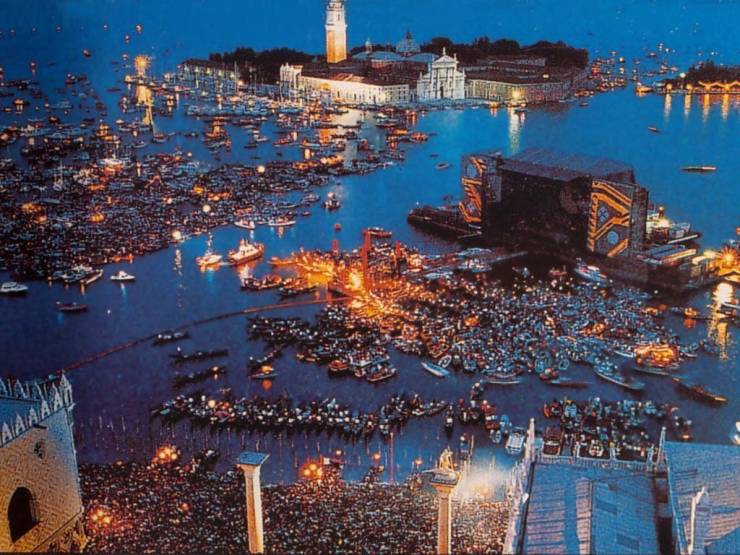 “Pink Floyd performing a free concert on a floating stage in Venice in 1989. The attendance was of 200,000. Venice has a population of around 270,000.”