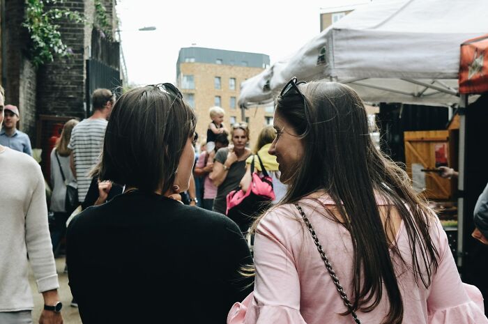 Walk like you know where you're going, make eye contact with strangers, and don't wear fancy clothes/purses/backpacks when walking around the neighborhood or using public transport