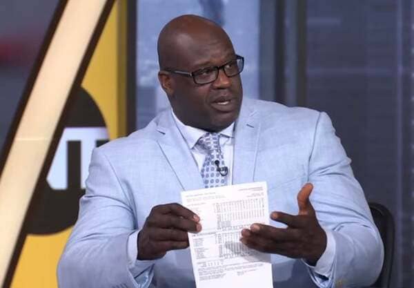 Shaq holding a regular sheet of paper.